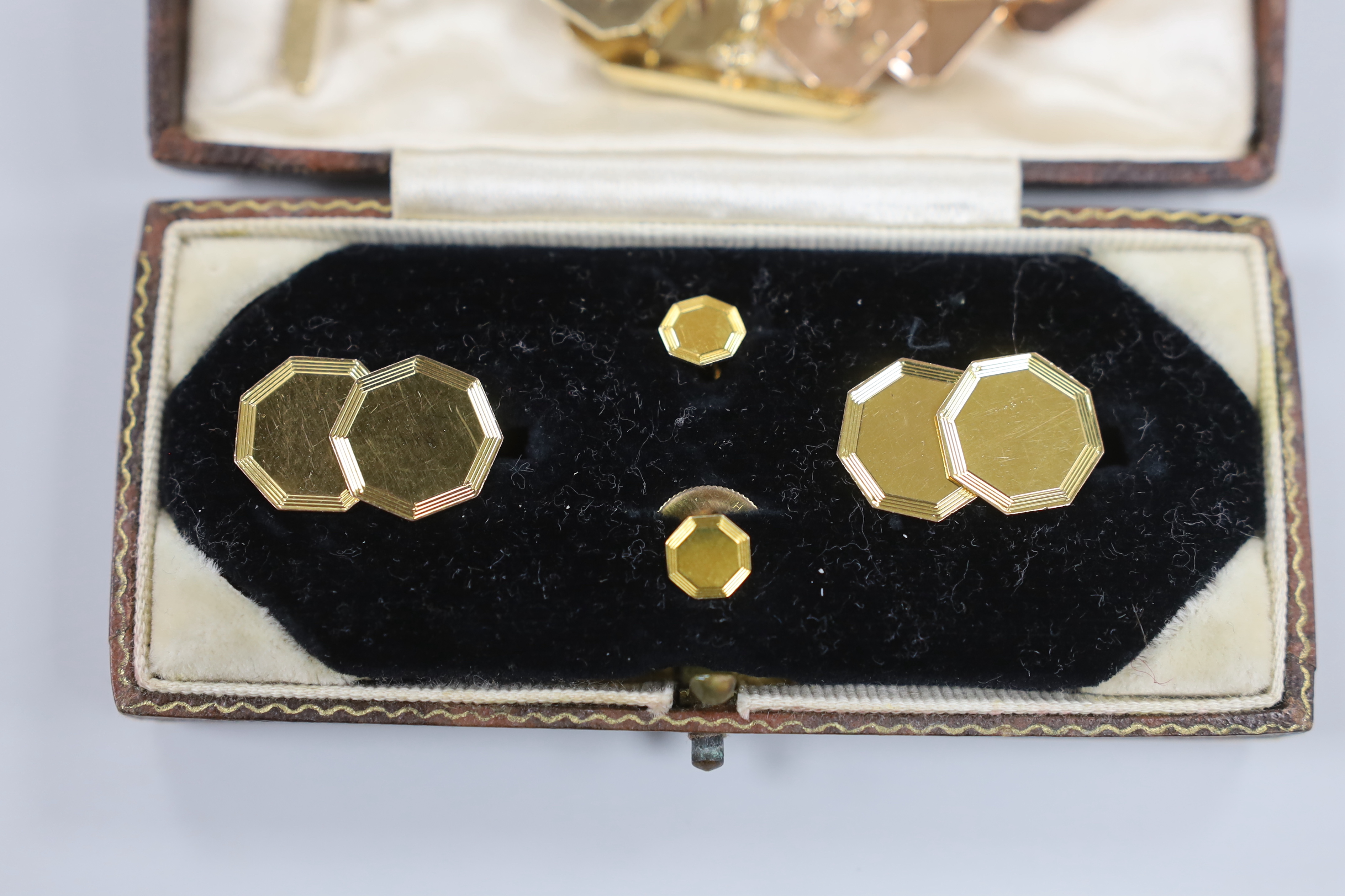 A cased 9ct gold four piece dress stud set including pair or cufflinks and three other pairs of yellow metal cufflinks (two pairs 9ct gold), gross weight 24 grams.